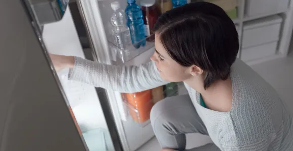 femme qui ouvre un frigo 