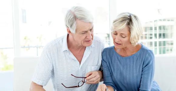 Un couple de seniors regarde une facture d'hôpital