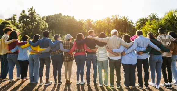 Des personnes de toutes origines et de tout âge présentés de dos en se tenant par les bras
