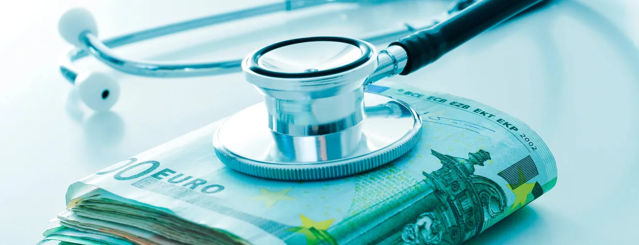 Une liasse de billets sur laquelle est posé un stéthoscope