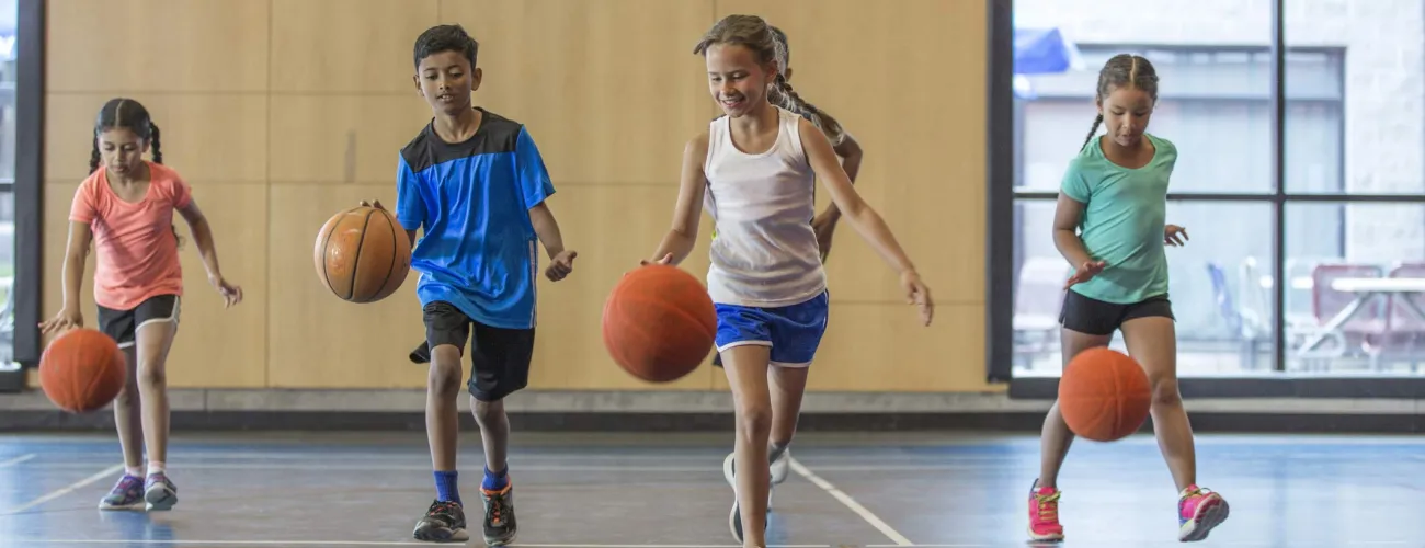 Un groupe d'enfants jouent au basketball