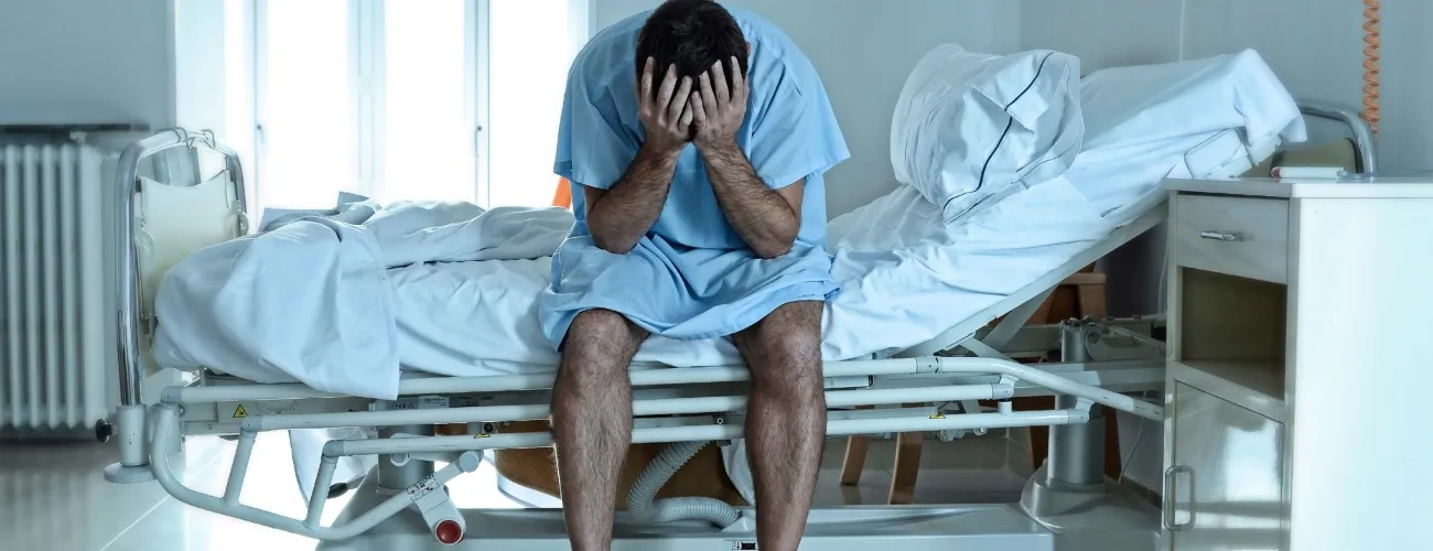 Un patient désespéré sur un lit d'hôpital
