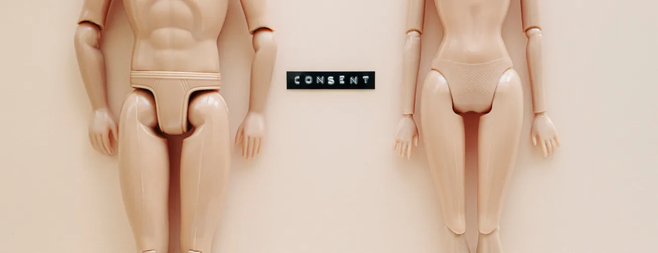 Deux poupées Barbie nues avec le mot "Consent"