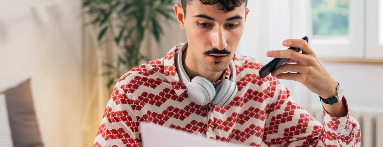 Un jeune homme lit un document papier